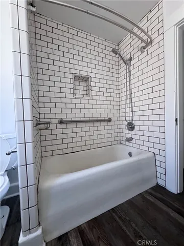 a bathroom with a tub sink and mirror