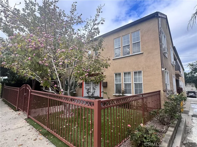 a view of a house with wooden fence
