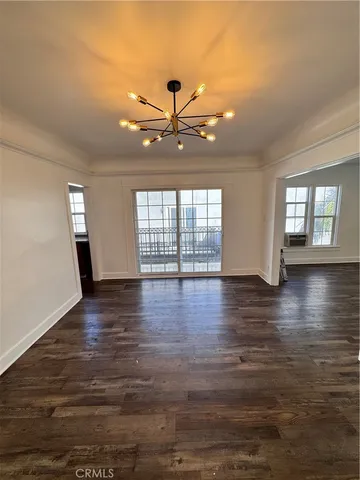 a view of a room with wooden floor