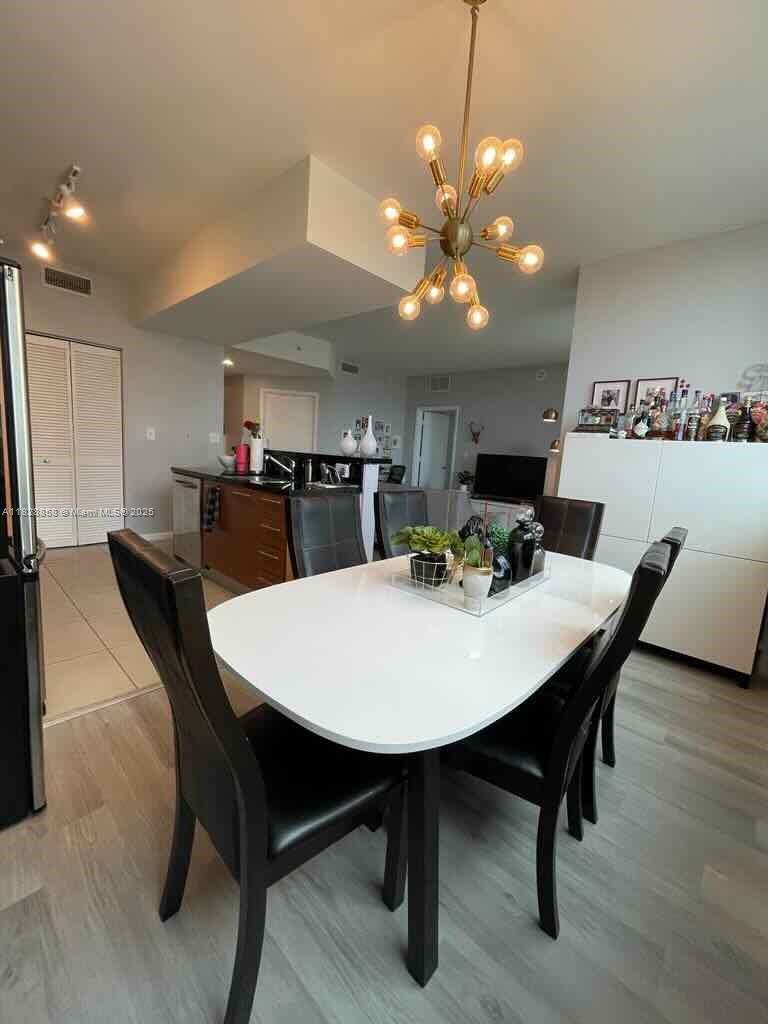244 Biscayne Boulevard, Unit 608 Miami, FL 33132 - Photo 11 of 25 a view of a dining room with furniture