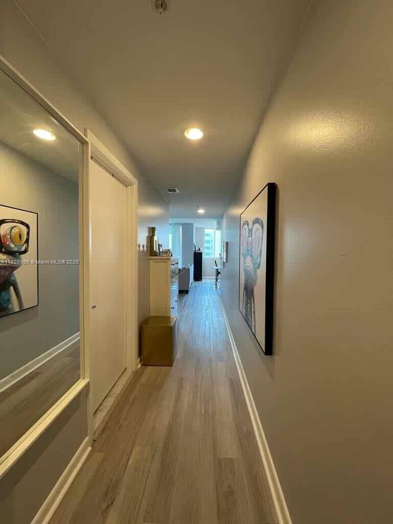 244 Biscayne Boulevard, Unit 608 Miami, FL 33132 - Photo 13 of 25 a view of a hallway with wooden floor