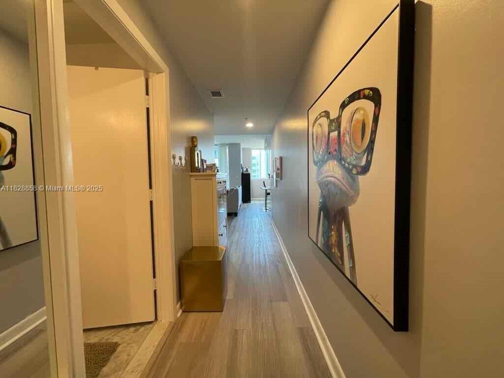 244 Biscayne Boulevard, Unit 608 Miami, FL 33132 - Photo 14 of 25 a view of a entryway door with wooden floor