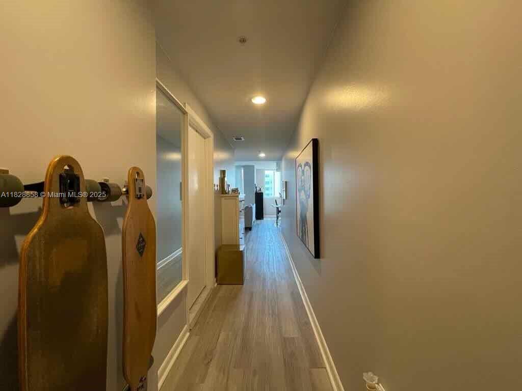 244 Biscayne Boulevard, Unit 608 Miami, FL 33132 - Photo 17 of 25 a view of hallway with wooden floor