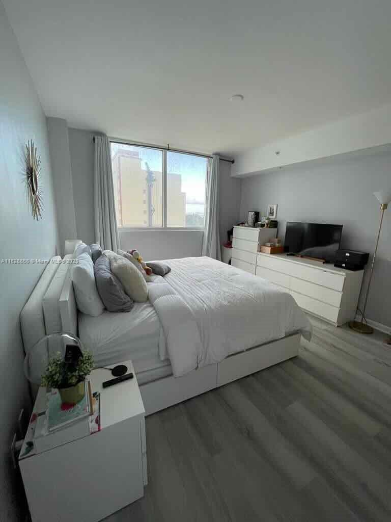 244 Biscayne Boulevard, Unit 608 Miami, FL 33132 - Photo 18 of 25 a bedroom with bed and window