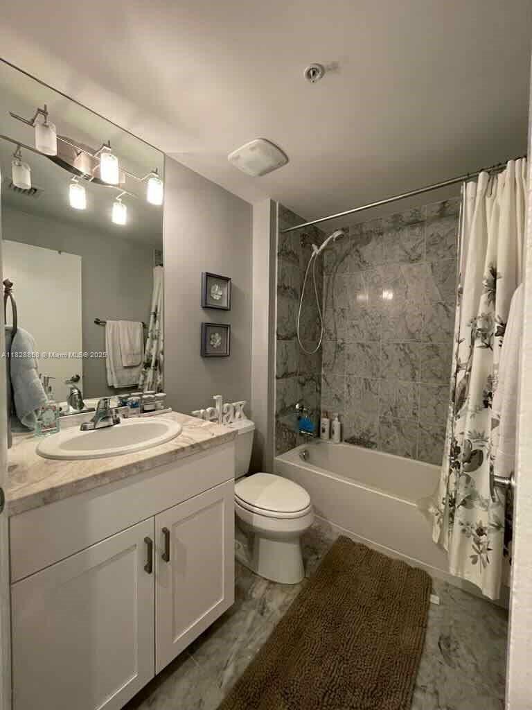 244 Biscayne Boulevard, Unit 608 Miami, FL 33132 - Photo 23 of 25 a bathroom with a sink a toilet and shower
