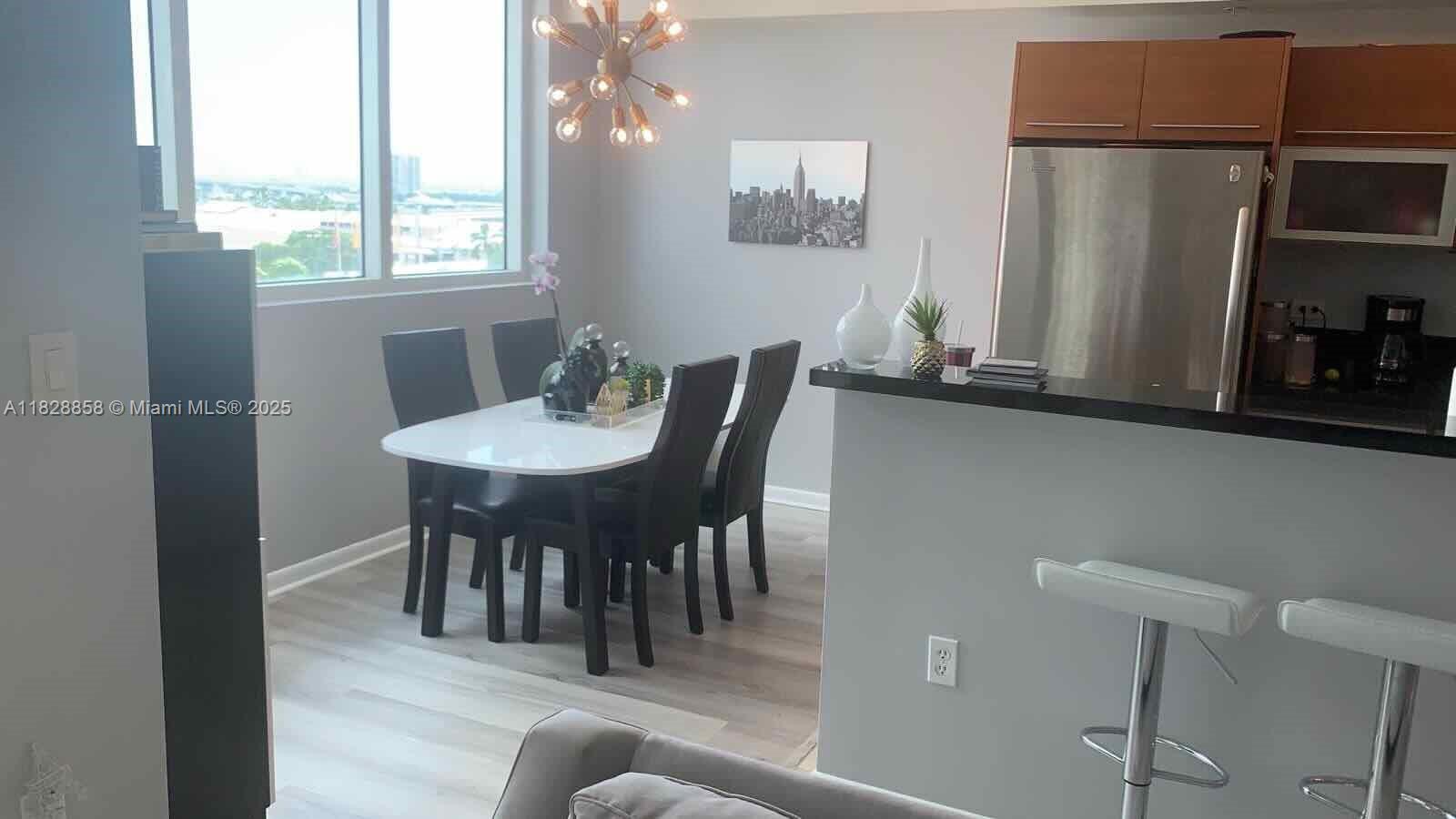 244 Biscayne Boulevard, Unit 608 Miami, FL 33132 - Photo 6 of 25 a view of a dining room with furniture and window