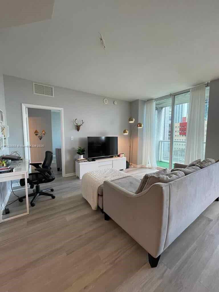 244 Biscayne Boulevard, Unit 608 Miami, FL 33132 - Photo 8 of 25 a living room with couches and furniture