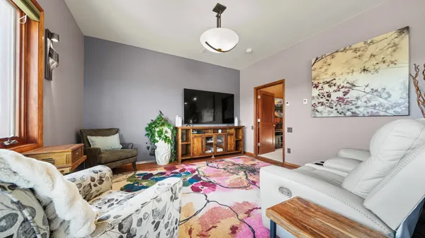 a bedroom with furniture and a large window