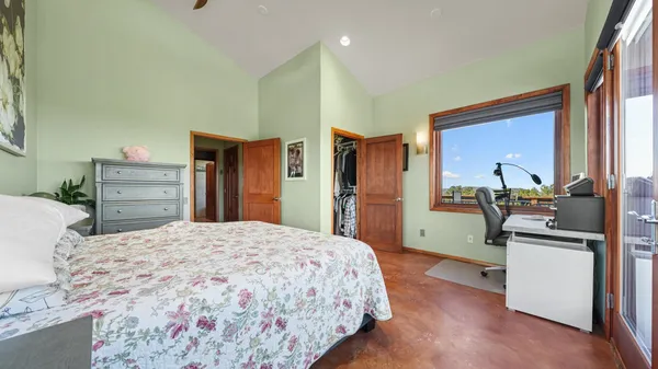 a bedroom with a bed and a large window