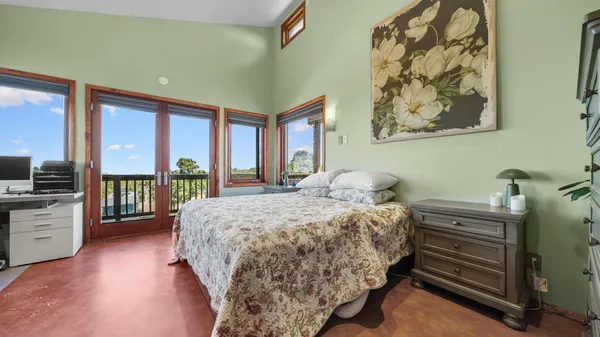 a bedroom with a bed desk and chair