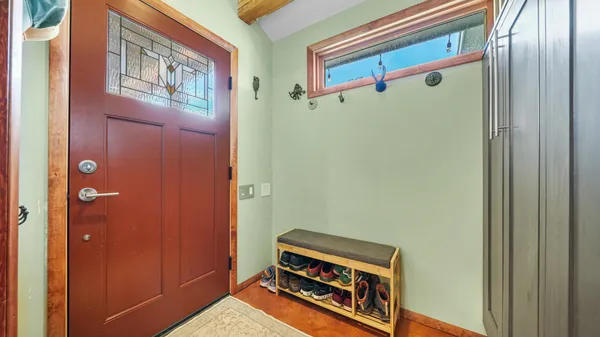a view of kitchen with stainless steel appliances granite countertop a refrigerator and a stove top oven