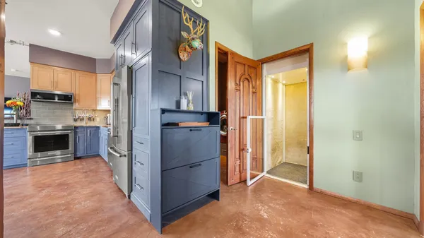 a kitchen with stainless steel appliances granite countertop a sink a stove and a wooden floors