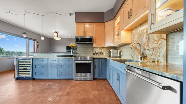 a kitchen with stainless steel appliances a refrigerator and a stove top oven