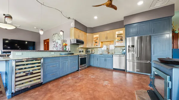 a kitchen with stainless steel appliances granite countertop a refrigerator and a sink