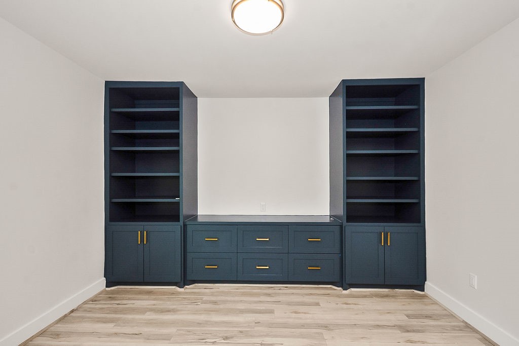 6106 Rutherglenn Drive Houston, TX 77096 - Photo 10 of 41 Built-in custom cabinetry and shelving adding style, storage, and functionality to the living space.