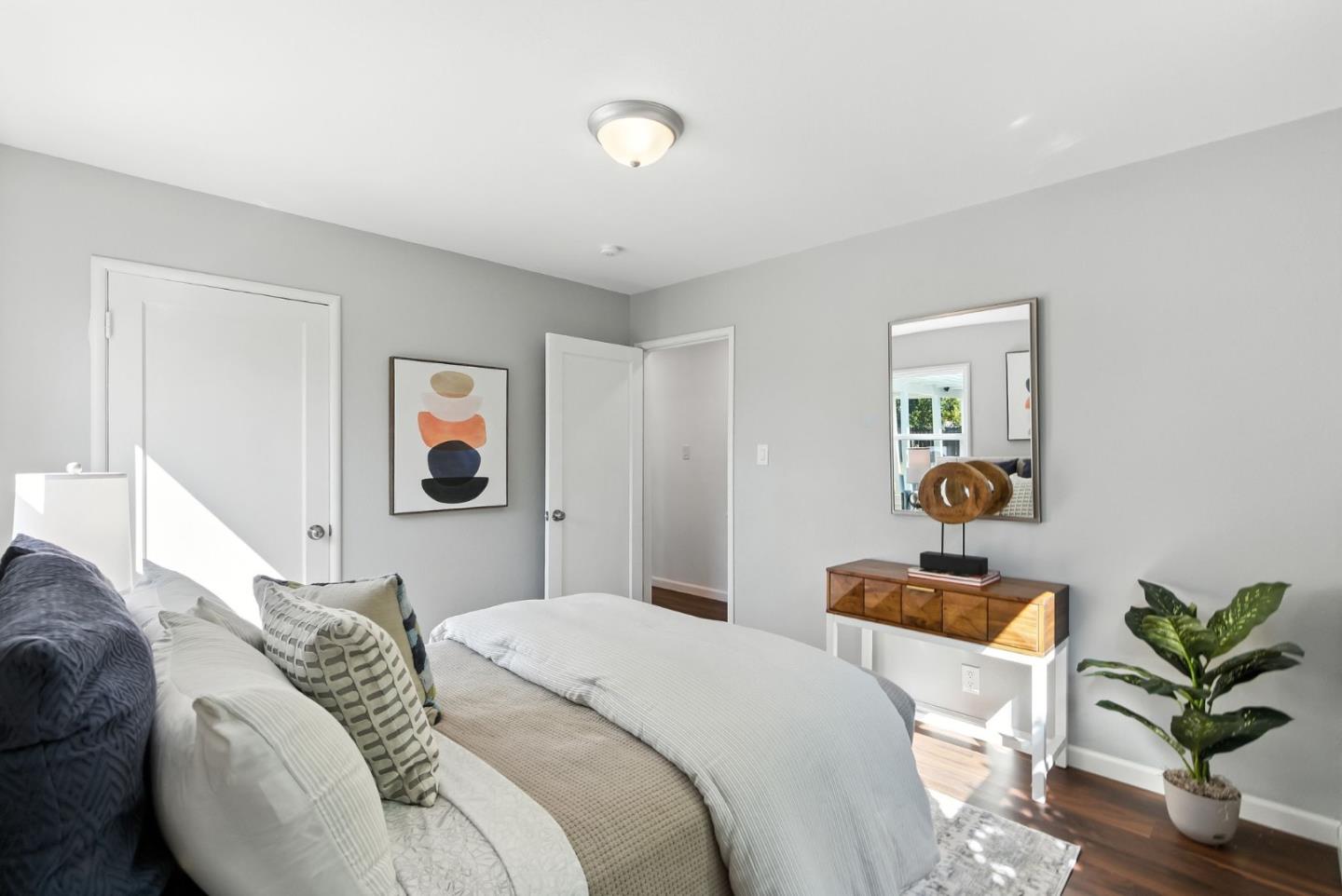 3612 Los Flores Avenue Concord, CA 94519 - Photo 27 of 65 a bedroom with bed and a potted plant