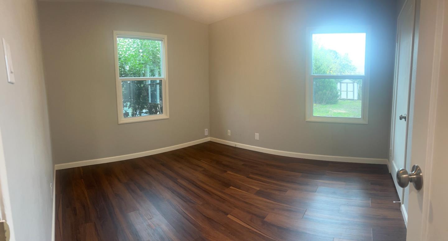 3612 Los Flores Avenue Concord, CA 94519 - Photo 56 of 65 an empty room with wooden floor and windows