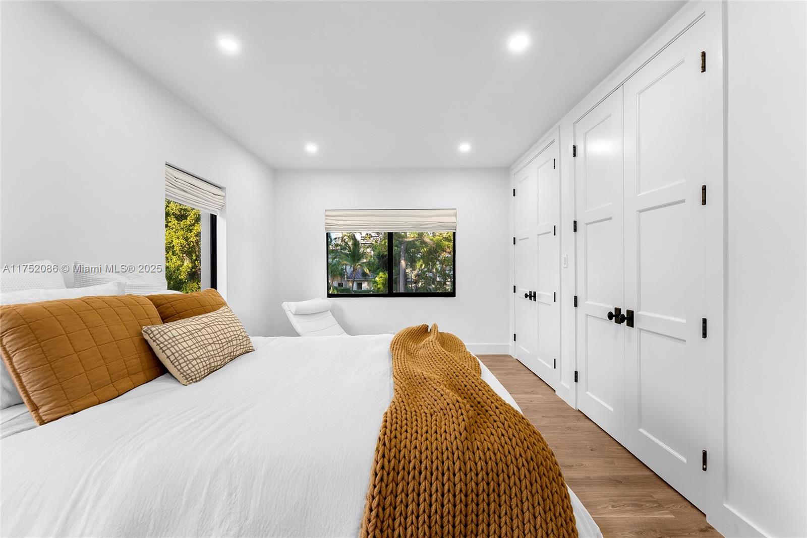 6146 Pine Tree Drive Miami Beach, FL 33140 - Photo 19 of 30 a bedroom with a bed and a window