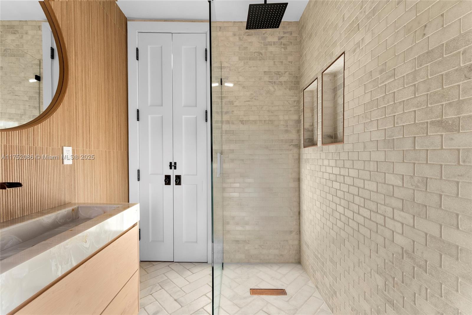 6146 Pine Tree Drive Miami Beach, FL 33140 - Photo 21 of 30 a bathroom with a granite countertop shower a mirror and a sink