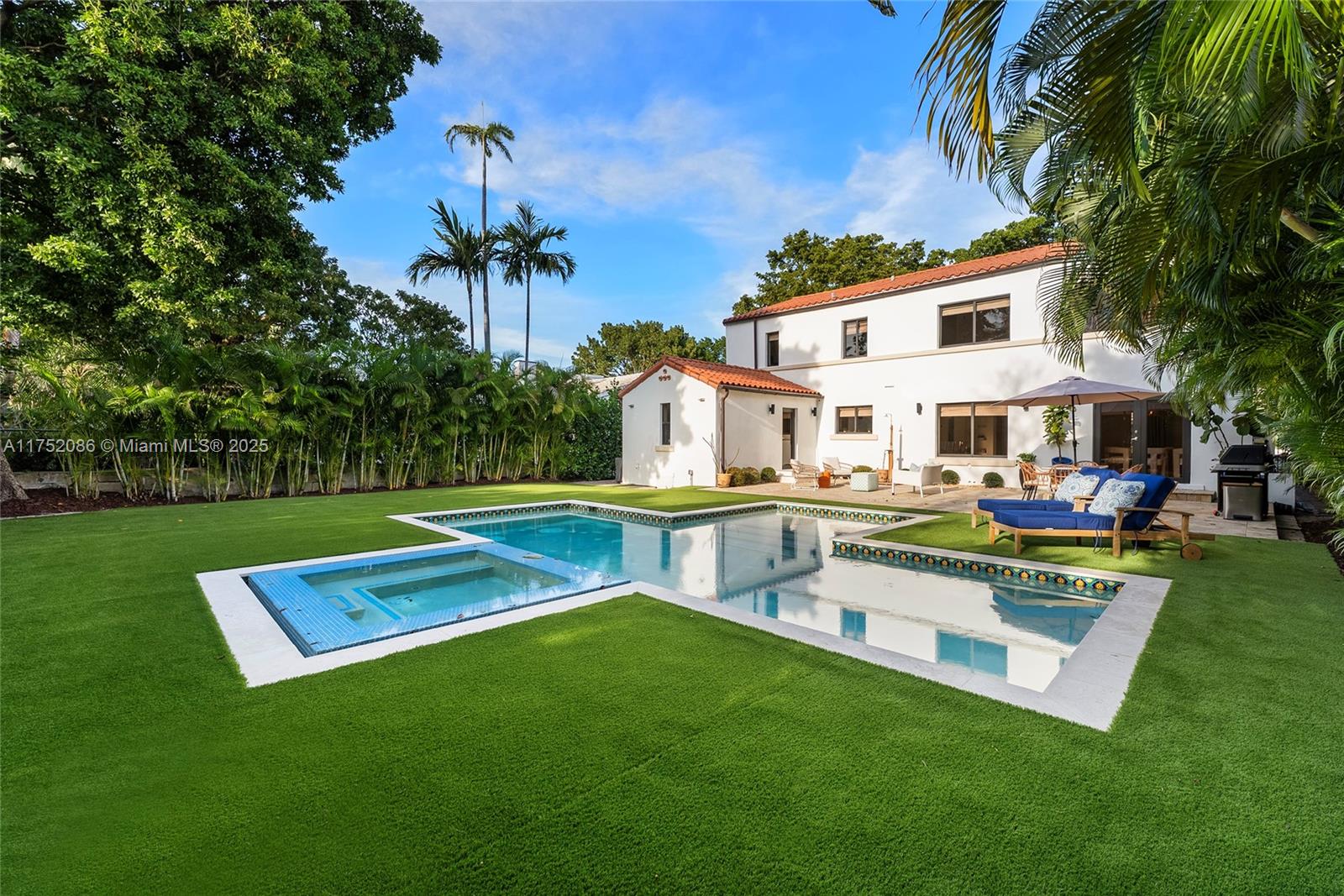 6146 Pine Tree Drive Miami Beach, FL 33140 - Photo 26 of 30 a view of a house with a yard patio and sitting area