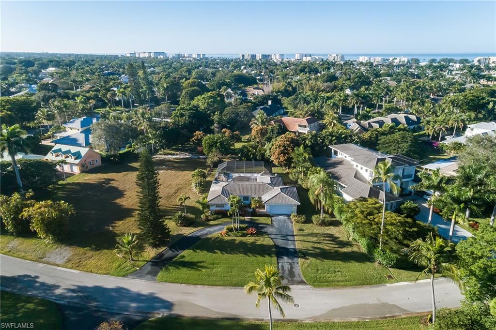 700 Bow Line Drive Naples, FL 34103 - Photo 1 of 18 an aerial view of residential houses with outdoor space and trees