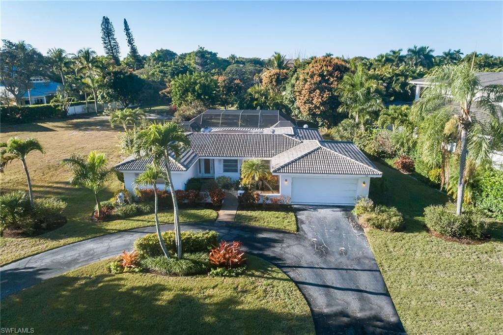 700 Bow Line Drive Naples, FL 34103 - Photo 2 of 18 a front view of a house with a yard