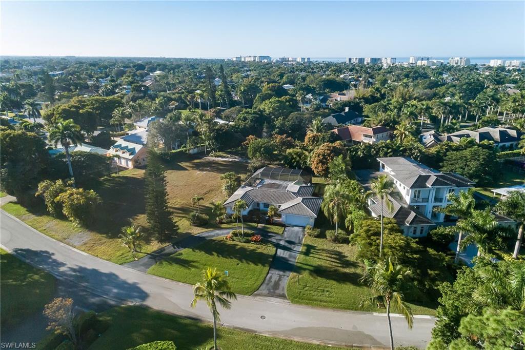 700 Bow Line Drive Naples, FL 34103 - Photo 3 of 18 an aerial view of residential houses with outdoor space and trees