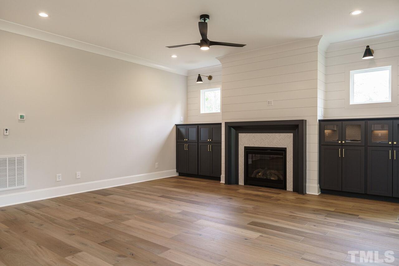 2609 Sanctuary Wds Lane Raleigh, NC 27606 - Photo 13 of 38 a view of an empty room with a fireplace and a window