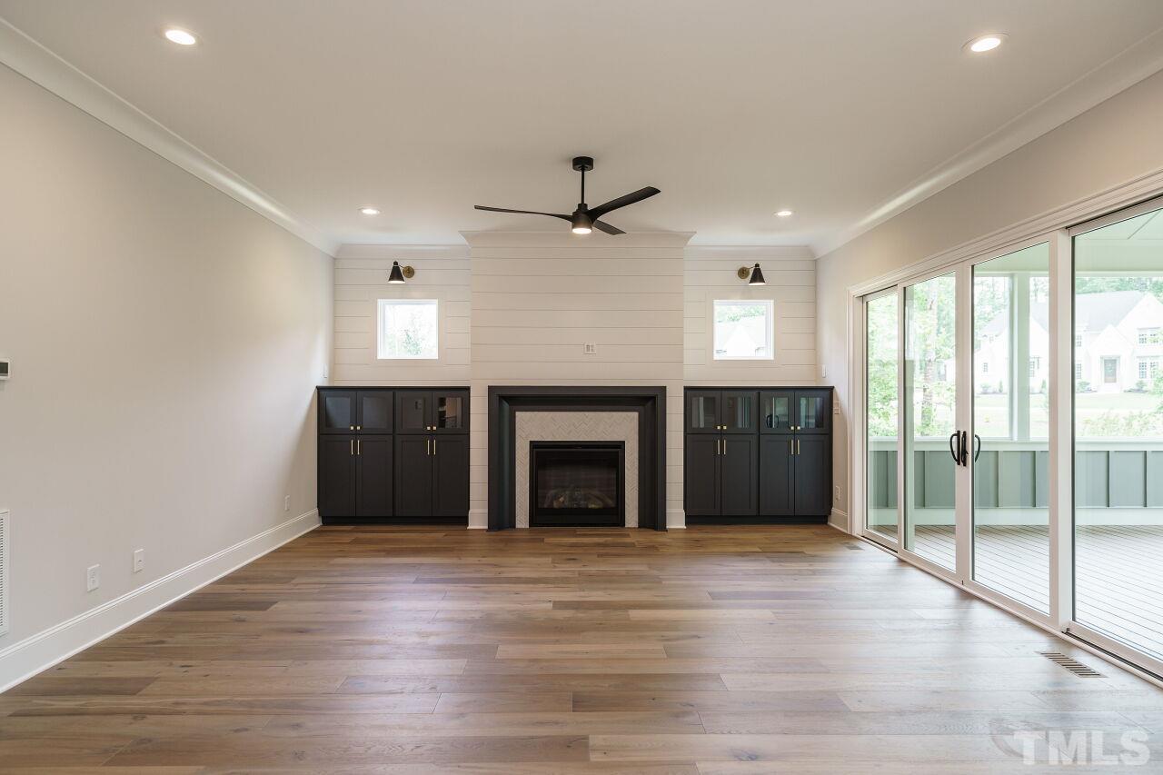 2609 Sanctuary Wds Lane Raleigh, NC 27606 - Photo 14 of 38 a view of an empty room with a fireplace and a window
