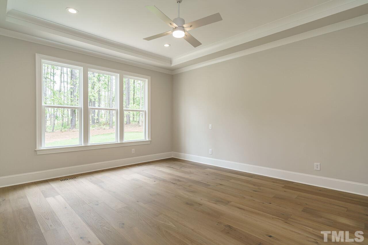 2609 Sanctuary Wds Lane Raleigh, NC 27606 - Photo 15 of 38 an empty room with wooden floor and windows