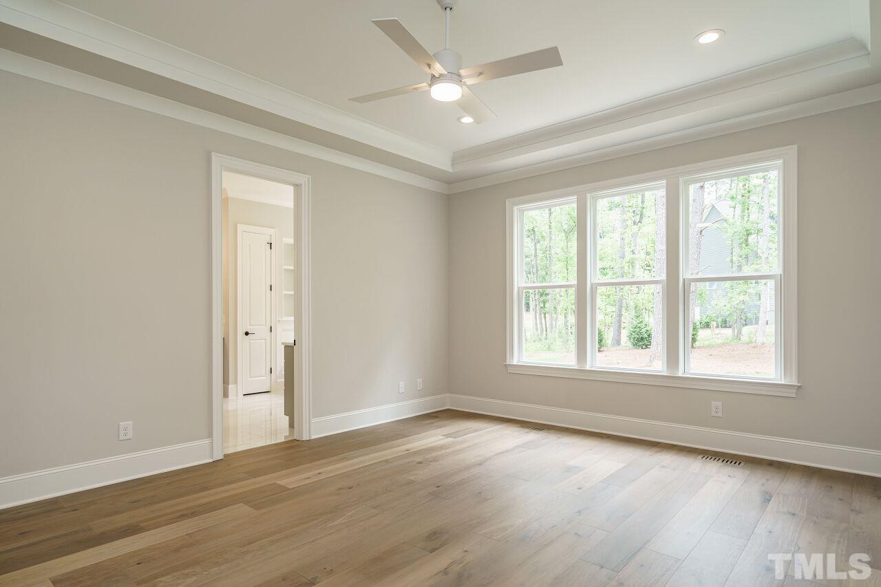 2609 Sanctuary Wds Lane Raleigh, NC 27606 - Photo 16 of 38 an empty room with wooden floor and windows