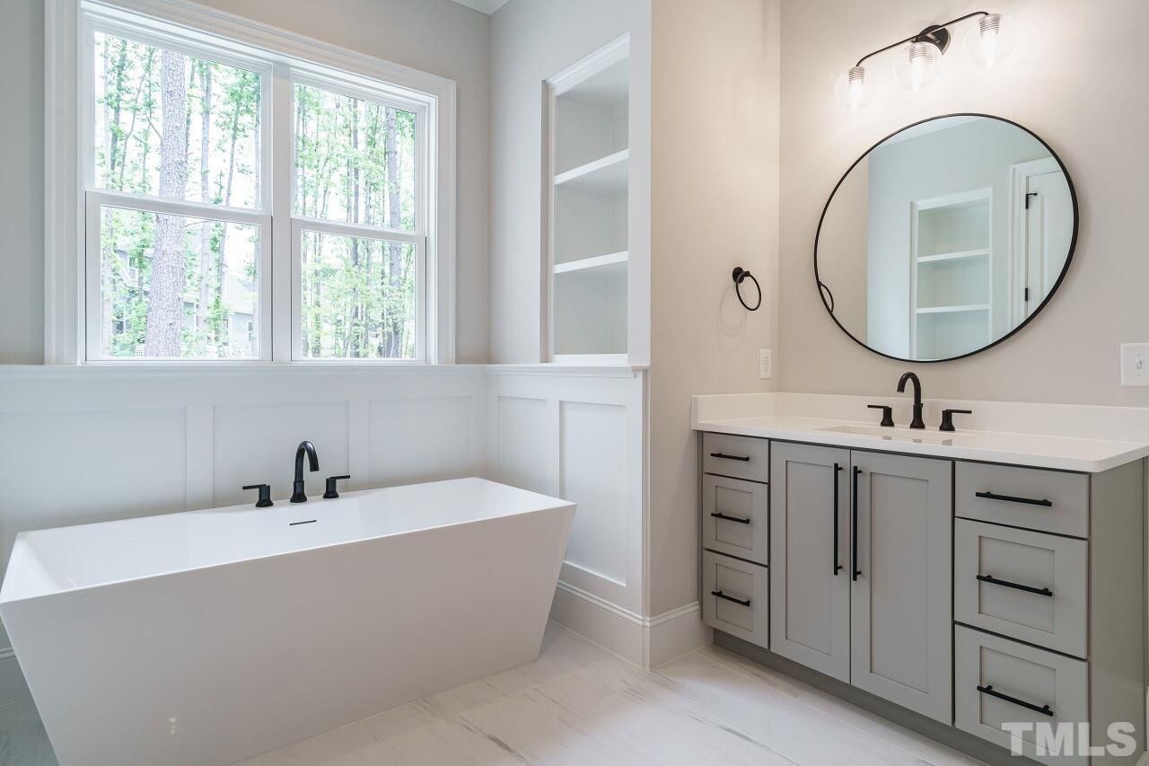 2609 Sanctuary Wds Lane Raleigh, NC 27606 - Photo 18 of 38 a bathroom with a double vanity sink and a mirror