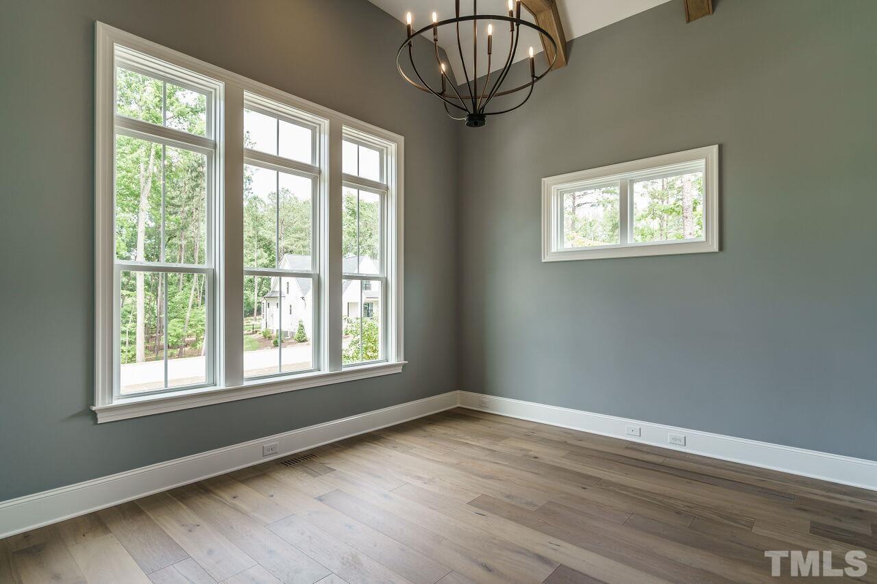 2609 Sanctuary Wds Lane Raleigh, NC 27606 - Photo 21 of 38 a view of empty room with wooden floor and fan