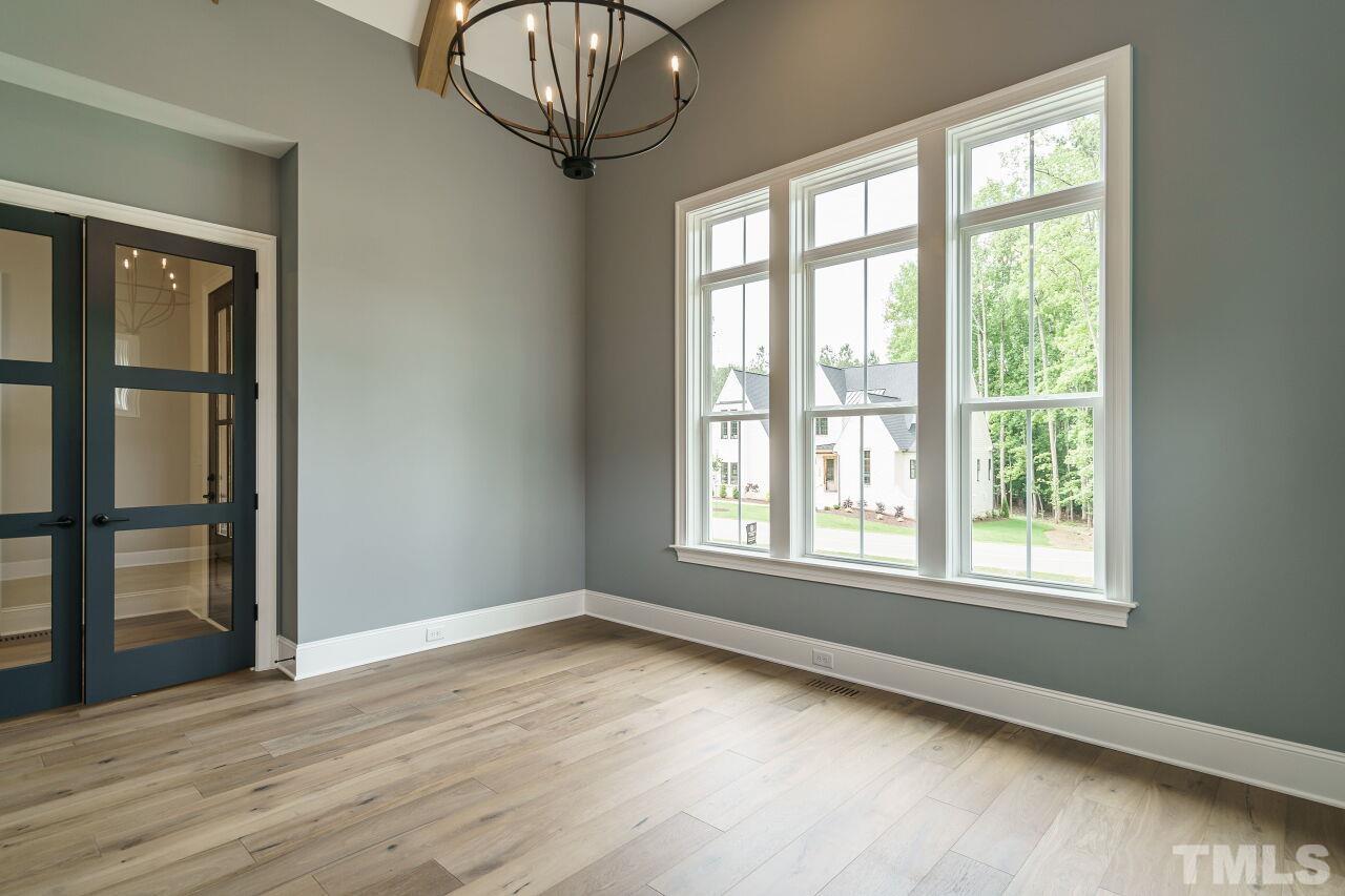 2609 Sanctuary Wds Lane Raleigh, NC 27606 - Photo 22 of 38 an empty room with wooden floor and windows