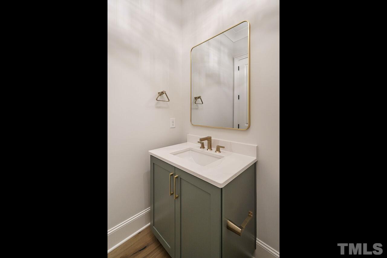 2609 Sanctuary Wds Lane Raleigh, NC 27606 - Photo 23 of 38 a bathroom with a sink and a mirror