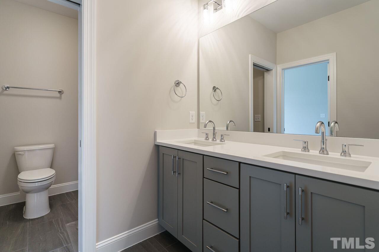 2609 Sanctuary Wds Lane Raleigh, NC 27606 - Photo 27 of 38 a bathroom with a toilet sink and mirror