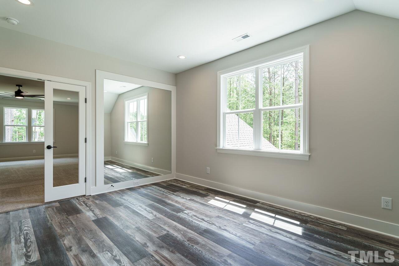2609 Sanctuary Wds Lane Raleigh, NC 27606 - Photo 29 of 38 an empty room with wooden floor and windows