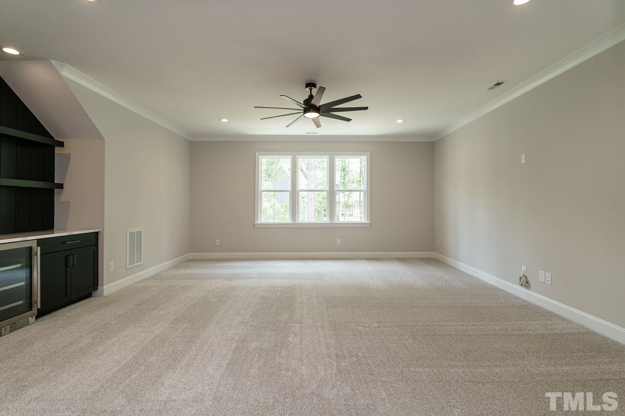 2609 Sanctuary Wds Lane Raleigh, NC 27606 - Photo 30 of 38 an empty room with windows and chandelier fan