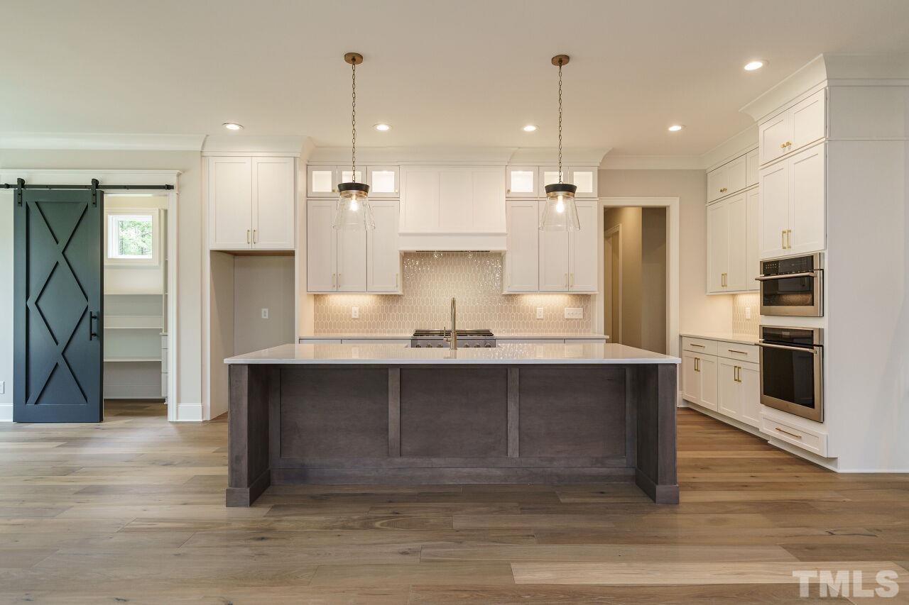 2609 Sanctuary Wds Lane Raleigh, NC 27606 - Photo 4 of 38 a view of a kitchen center island wooden floor and kitchen view
