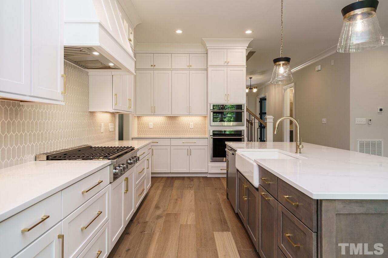 2609 Sanctuary Wds Lane Raleigh, NC 27606 - Photo 6 of 38 a kitchen with a sink stove top oven and cabinets