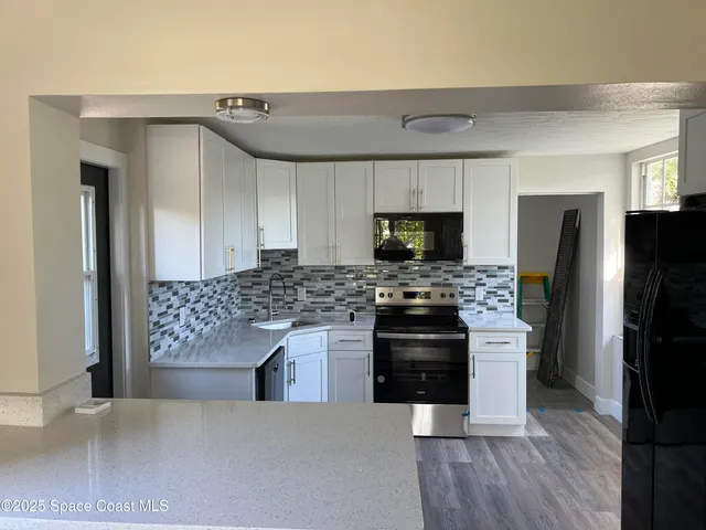 a kitchen with a stove and a refrigerator