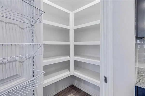 a view of walk in closet with empty racks