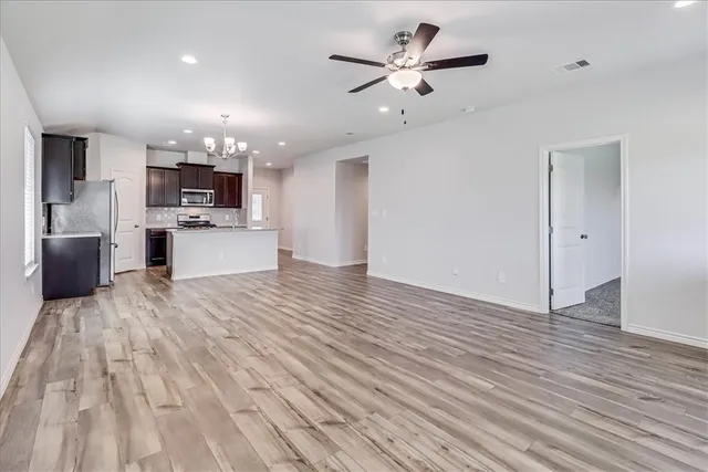 a view of a kitchen with a sink and dishwasher with wooden floor