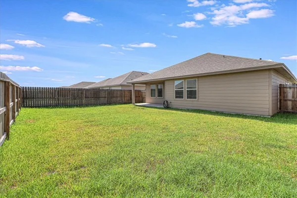 a view of a house with a backyard
