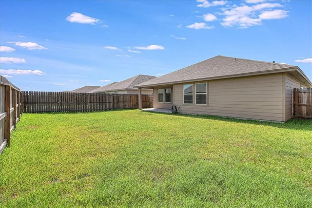 a view of a house with a backyard