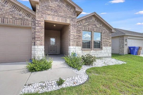 a front view of a house with garden