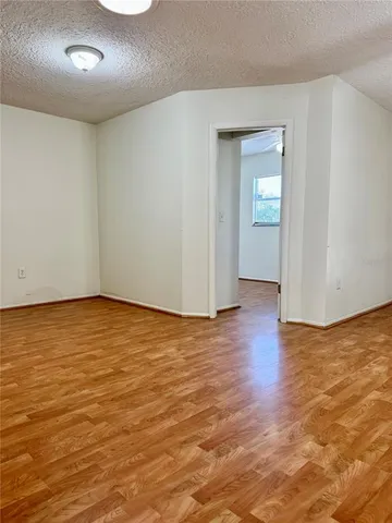 an empty room with wooden floor and closet