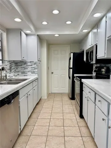 a kitchen with stainless steel appliances a refrigerator sink and microwave