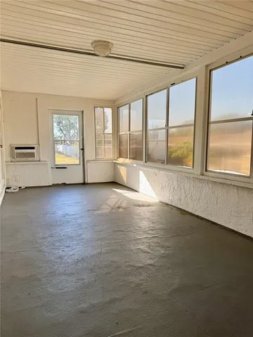 an empty room with large windows
