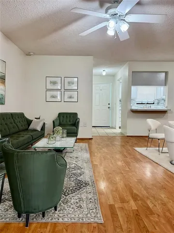 a living room with furniture and a chandelier